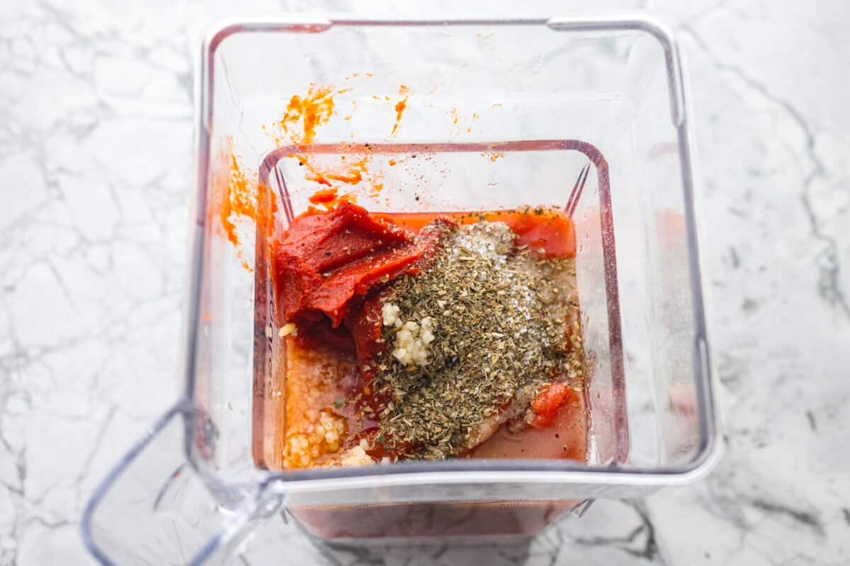 After re-testing this Homemade Marinara Sauce, I can confidently say itโs the BEST! You can make it in 15 minutes, but letting it simmer makes the flavors even better! Marinara sauce ingredients added to a blender.