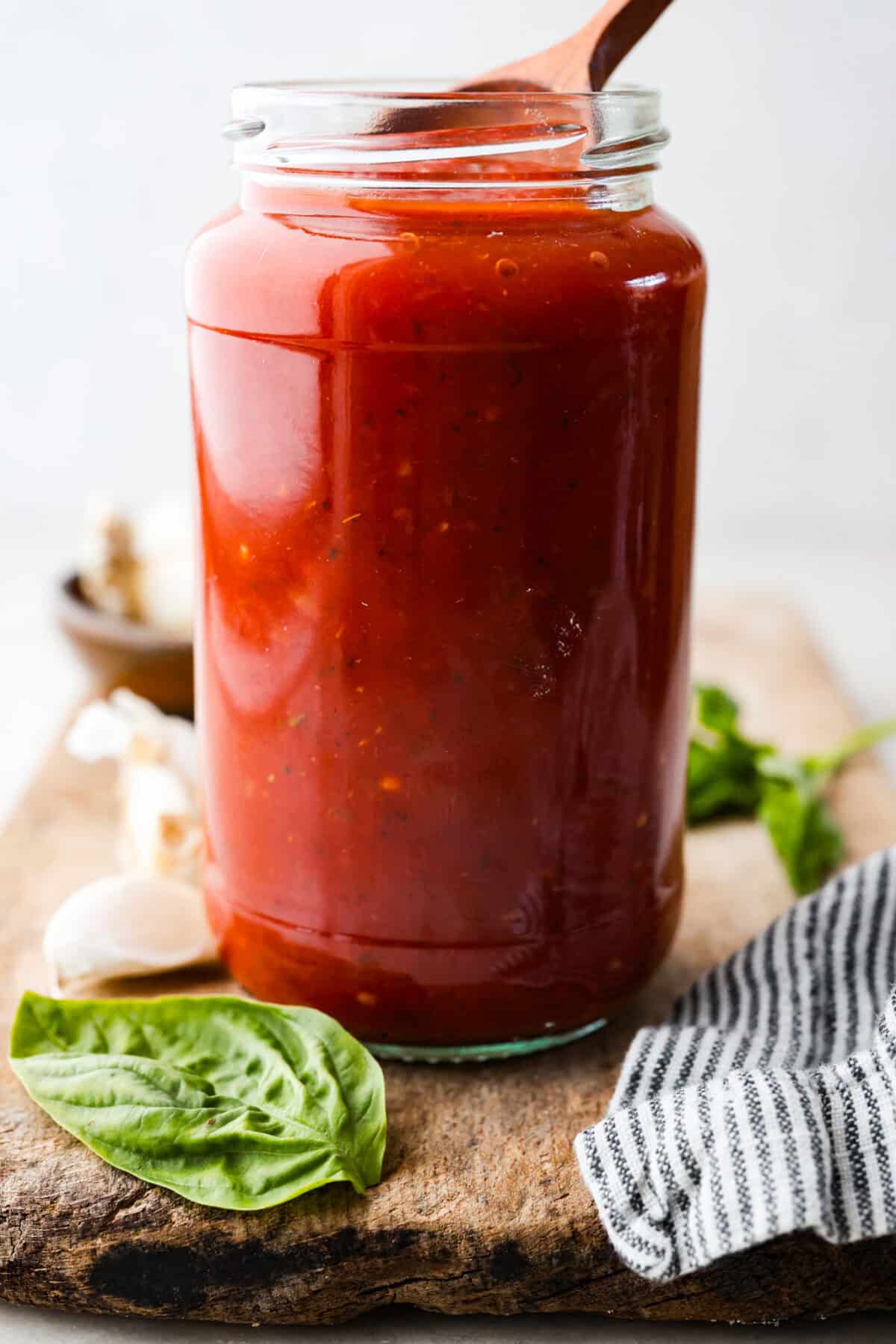 After re-testing this Homemade Marinara Sauce, I can confidently say itโs the BEST! You can make it in 15 minutes, but letting it simmer makes the flavors even better! A glass jar filled with homemade marinara sauce.